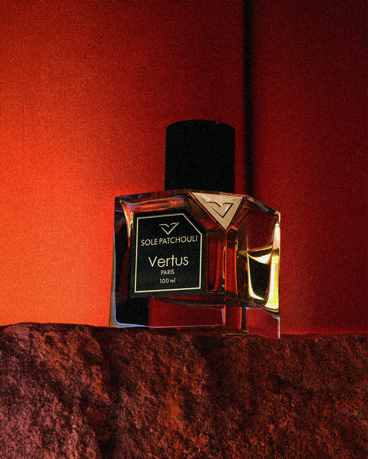 Vertus Sole Patchouli Eau De Parfum luxury niche perfume bottle with patchouli and amber notes on warm textured background